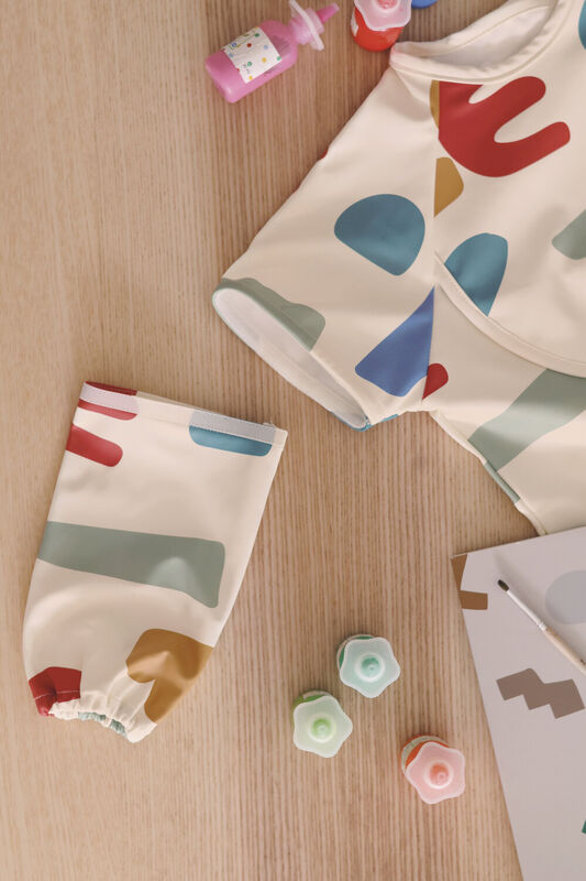 2 in 1 Evolutionary Bib with removable handle and foldable pocket - Playful 